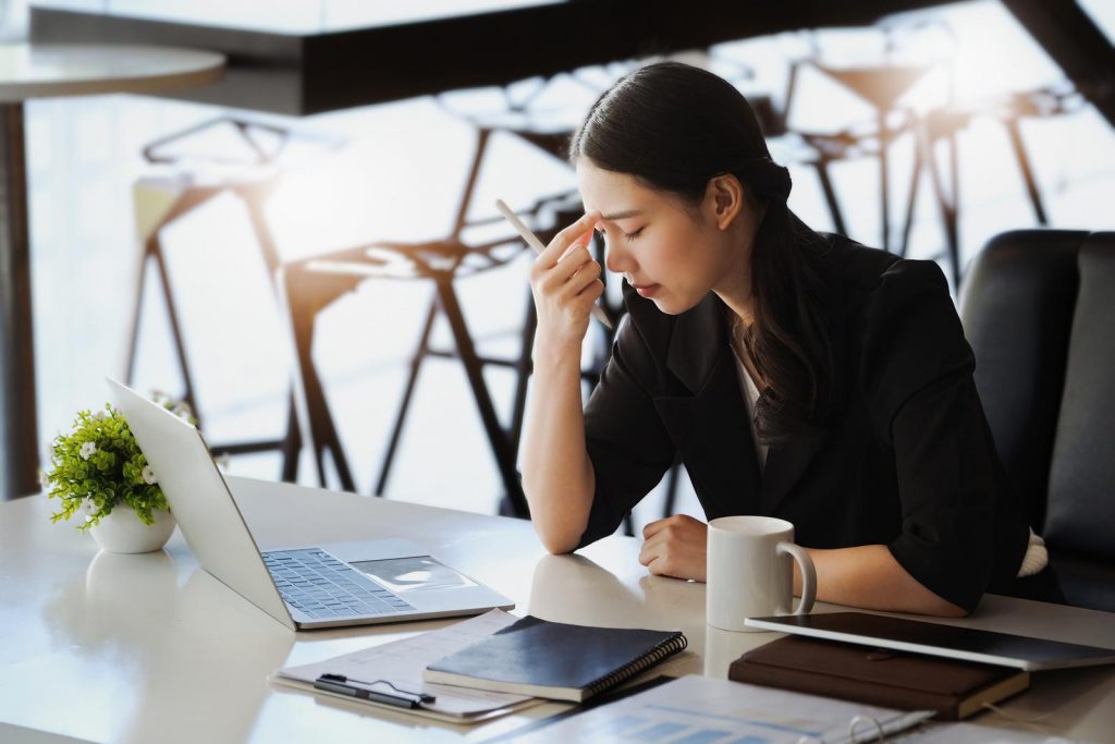 company employees show boredom from unfinished work using computer notebook documents and tablets at work